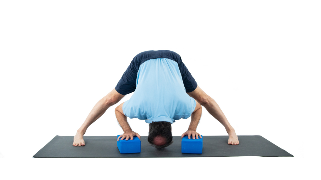 Yogi in Prasarita Padottanasana a yoga pose that helps to relieve tightness in the shoulders